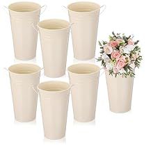 six white buckets with flowers in them