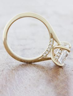 a close up of a diamond ring on a table