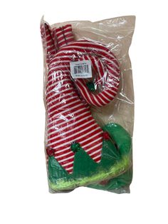 a red and white striped christmas stocking with an alligator on it's back