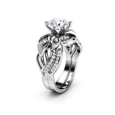 a white gold engagement ring set with a flower and leaves design