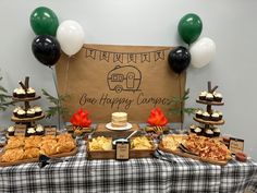 a table topped with lots of food and balloons