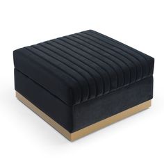 a black velvet ottoman with gold trimmings and a square foot rest on top