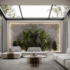 a living room filled with white furniture and plants