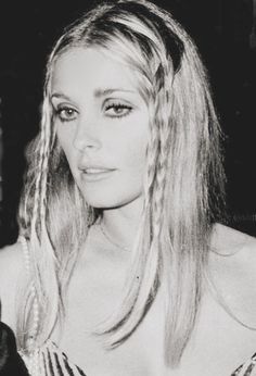 an old photo of a woman with long blonde hair and braids on her head