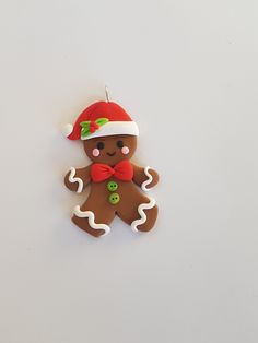 a christmas ornament shaped like a ginger with a red hat and bow tie