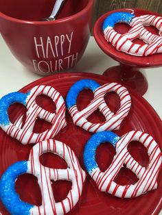 red, white and blue pretzels with happy fourth written on them sitting on a plate