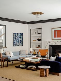 a living room filled with furniture and a fire place