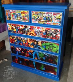 a blue dresser with comics painted on it