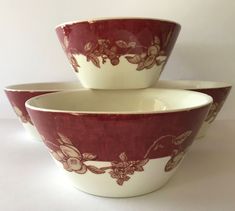 three red and white bowls sitting next to each other