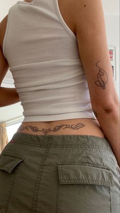 a woman with a tattoo on her lower back