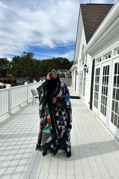 Rich Auntie at it's finest! Our fashion winter long hooded kimono is a fun, colorful and flowy kimono. Open front styling , bold print and hood makes this a statement piece you will want in your closet. One Size fits up to 4X as the sleeves are open flowy and the poncho has an open front. Styling tip: Can be worn over jeans, boots, dresses, or on it's own! Easy transition piece for a coat! Styling options are endless! Fabric composition is tencil wool polyester blend for a flowy fit. Fabric is n Oversized Black Outerwear For The Beach, Oversized Black Winter Kimono, Oversized Black Kimono For Winter, Multicolor Oversized Shawl Outerwear, Oversized Multicolor Cape Outerwear, Oversized Winter Kimono With Kimono Sleeves, Oversized Kimono With Kimono Sleeves For Winter, Multicolor Long Sleeve Cape For Winter, Multicolor Long-sleeved Winter Cape