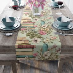 the table is set with flowers and books