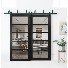 a living room with sliding glass doors that open up to the bedroom and dining area