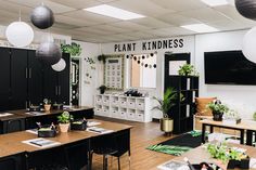 a classroom with desks, chairs and plants