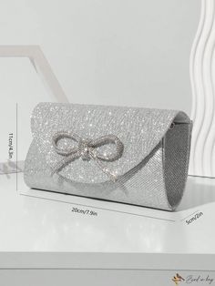 Bird in Bag - Premium Silver Evening Bag with Chain, adorned with Mini Glitter Rhinestone Bowknot: Ideal for Party or Wedding, a Must-Have Hand Bag for Fashionable Women Silver Evening Bag For Party Season Events, Glitter Clutch Evening Bag For Event, Glitter Clutch Evening Bag For Events, Silver Clutch For Formal Party Season, Silver Clutch For Formal Parties, Silver Clutch For Formal Occasions During Party Season, Elegant Silver Bags For Party Season, Elegant Sparkling Bags For Prom, Elegant Silver Party Season Bags