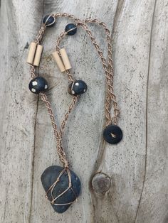 "Handmade macrame necklace with Basalt Stone handpicked from the Chesapeake Bay. Features wooden and lava stone beads. Necklace length is small-medium, sits about 17\" on me. Why Buttons?  All my pieces have button clasps instead of traditional jewelry clasps. I started making my own jewelry because I have a sensitivity to most metals and I wasn't able to find jewelry I wasn't allergic to. Buttons were the first thing I found that worked with my sensitive skin and they just stuck! As a bonus, they're much more accessible for people with limited mobility! Where Do the Beads and Stones Come From?  Almost all of my beads and buttons are recycled from old jewelry or purchases secondhand. I prioritize making use of things that otherwise would be discarded. If I buy new beads, I try to buy from Adjustable Wooden Beads Necklace In Nature-inspired Style, Hand-strung Adjustable Natural Necklace, Adjustable Macrame Necklace In Nature-inspired Style, Nature-inspired Adjustable Macrame Necklaces, Adjustable Rustic Necklace With Waxed Cord, Rustic Adjustable Necklace With Waxed Cord, Rustic Adjustable Natural Necklace, Adjustable Hand-strung Nature-inspired Beaded Necklaces, Handmade Cord Jewelry For The Beach