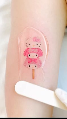 a hello kitty sticker on the side of a woman's leg