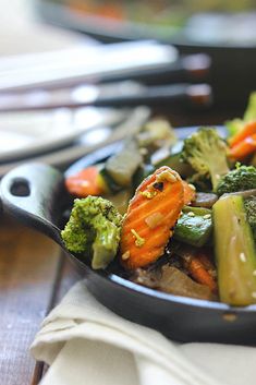 a pan filled with vegetables sitting on top of a table