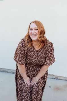 Stay stylish with the Emsley Midi dress! Featuring a charming brown color with delicate white florals, this dress is designed with a smocked bodice and flared bubble sleeves for a fun and flattering look. Plus, it has pockets for added convenience. Look effortlessly chic in this must-have dress! The Emsley Midi is lined. Fits true to size. Model is wearing a small and is 5'10". Plus model is wearing a 2X and is 5'6". Size Chart Length Bust Waist S 46" 30" 28" M 46" 32" 30" L 47" 34" 32" XL 48" 3 Brown Midi Length Dress With Smocked Back, Brown Puff Sleeve Dress With Smocked Bodice, Spring Brown Midi Dress With Smocked Bodice, Spring Brown Smocked Dress, Brown Smocked Dress For Spring, Brown Short Sleeve Dress With Floral Print, Brown Smock Spring Dress, Brown Smock Dress For Spring, Brown Smocked Spring Dress