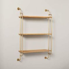 a wall mounted shelf with three shelves on each side and two hooks in the middle