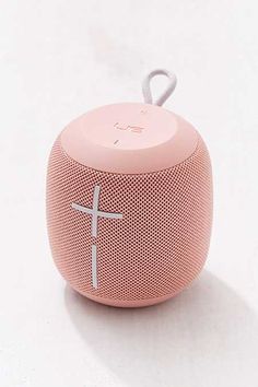 a pink bluetooth speaker with a cross on it