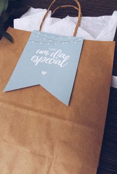 a brown paper bag sitting on top of a wooden table