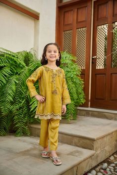 2-Piece Embroidered Suit for Girls (shirt & trouser only) : A classic Intricately crafted design and captivating details make this two-piece staple a perfect style statement for you and your little one. Description -- Kameez (Shirt) : Paper Cotton shirt engraved with floral embroidered details and mirror embellishment. Lining included. -- Shalwar (Trouser) : Green Pants. General Care Instruction : Should be hand washed and hung to dry. Color may bleed so please be mindful of other items with it. Long Sleeve Sets With Embroidered Border For Diwali, Festive Sets With Dabka Work For Spring, Embroidered Cotton Pant Set For Eid, Festive Embroidered Cotton Pant Set, Festive Spring Sets With Dabka Work, Eid Embroidered Cotton Pant Set, Festive Cotton Set With Embroidered Border, Festive Cotton Pant Set With Embroidered Border, Festive Cotton Sets With Embroidered Border