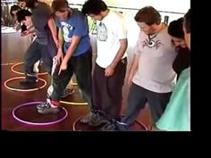 a group of young men standing next to each other on top of frisbees