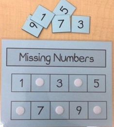 missing numbers on a wooden table with blue and white cards next to each one that says missing numbers