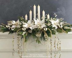 a decorated mantle with candles and flowers on it