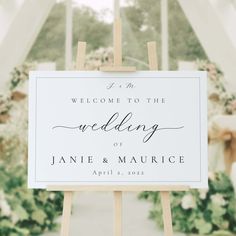 a welcome to the wedding sign on a easel