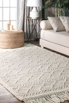 a living room with a white couch and rug