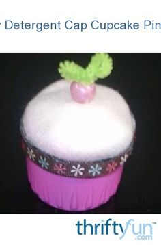 a close up of a cupcake with frosting and a green leaf on top