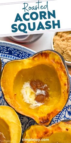 baked acorn squash on a blue and white plate with the words roasted acorn squash