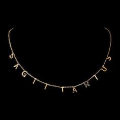 a gold necklace with the word love spelled on it and letters hanging from each side