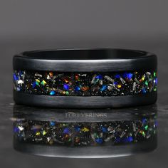 ►Material: Tungsten Carbide, Meteorite, Opal ►Color: Black ►Comfort Fit ►Band width: 8mm ►Fit is true to size. ►This hand-crafted tungsten ring features a stunning inlay of galaxy opal and meteorite flakes. The meteorite flakes are sourced from genuine Gibeon meteorite. The opal showcases a dazzling array of iridescent colors in sunlight. A beautiful alternative for a wedding band, this ring will stand out amongst the crowd of standard wedding bands. ►Opal has numerous positive attributes and me Black Opal Wedding Band, Positive Attributes, Meteorite Wedding Band, Wedding Band Black, Opal Wedding Band, Gibeon Meteorite, Partner Rings, Black Opal Ring, Black Tungsten Rings