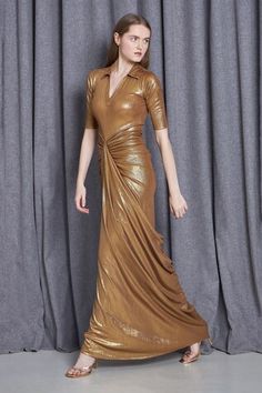 Metallic gold half sleeves draped gown with a collar neckline crafted in knit lame base - Aza Fashions Festive Draped Fitted Evening Dress, Festive Fitted Draped Evening Dress, Elegant Gold Evening Dress With Short Sleeves, Gold Hand-embellished Gown With Traditional Drape, Gold Fitted Draped Dress, Gold Chainmail Dress, Luxury Metallic Draped Dress, Chic Metallic V-neck Dress, Elegant Metallic V-neck Maxi Dress