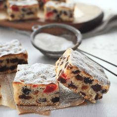 several pieces of cake sitting on top of a wooden cutting board