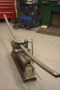 an assembly line in a garage with tools on the floor