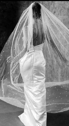 a woman wearing a wedding dress and veil