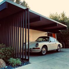 a car is parked in front of a house with a carport attached to it