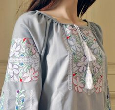 Beautiful grey blouse Ukrainian style blouse with white flowers Embroidered shirt Ukrainian vyshyvanka Homespun cloth trendy blouse Modern Made of homespun cloth fabric, this fashionable machine embroidered blouse is very easy to match with skirts or pants, including jeans. Homespun cloth is a cotton fabric of special weave made in up to date version on the base of traditional technics. Please, note it contains added synthetic fibers (up to 30%) to make it soft, long-term and durable in wear. Pr Ukrainian Vyshyvanka, Ukrainian Style, Flowers Embroidered, Trendy Blouse, Grey Blouse, Trendy Blouses, Cloth Fabric, Style Blouse, Embroidered Blouse