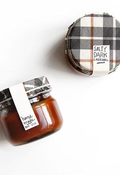 two jars of jam sitting next to each other on a white surface with a label that says salty park