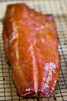 a piece of meat sitting on top of a metal rack