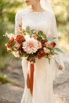 a woman in a wedding dress holding a bouquet