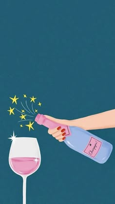 a hand holding a bottle and a wine glass with pink liquid in it on a blue background