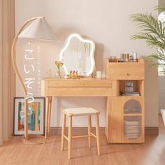 a wooden desk with a mirror and stool in front of it on top of a hard wood floor