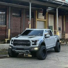 a silver truck parked in front of a building