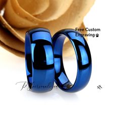 two blue wedding rings sitting next to each other