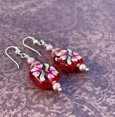 Floral Painted Art Glass Earrings With Swarovski Pearls, Czech Pressed Glass, and Sterling Silver - Etsy Handmade Pink Glass Jewelry, Handmade Pink Czech Glass Jewelry, Beaded Czech Glass Flower Earrings Gift, Hand Painted Red Dangle Jewelry, Red Hand Painted Dangle Jewelry, Red Hand-painted Dangle Jewelry, Pink Flower Glass Jewelry, Beaded Flower Earrings With Czech Glass For Gifts, Pink Flower-shaped Glass Jewelry